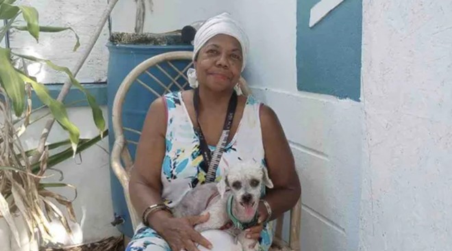 Gloria Francine Maxwell, with one of her dogs, which died in a house fire on June 23, 2022.