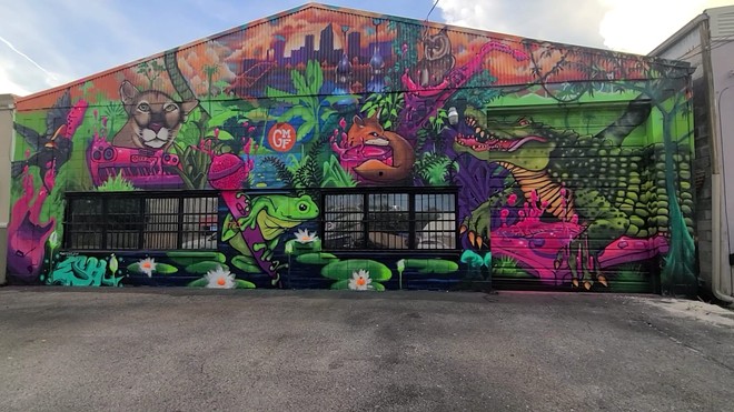 Eric Hornsby’s GMF mural features a red-winged blackbird perched on the neck of a guitar, a Florida panther on keys, a tree frog latched onto a microphone, an owl on sax, a fox on drums, and an alligator working the turntables. - Photo via hornsbygator/Facebook