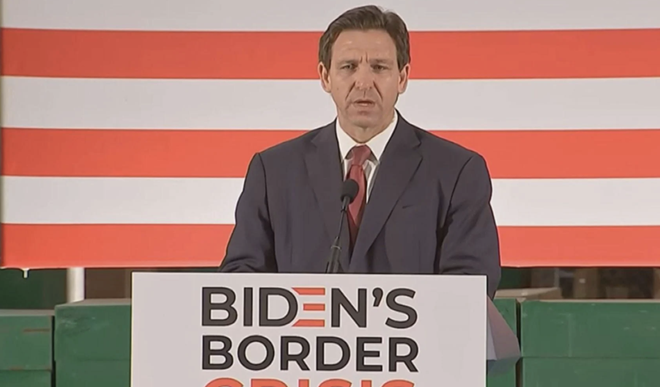 Gov. Ron DeSantis signing immigration bill during an appearance in Jacksonville. - Photo via Tom Urban/NSF