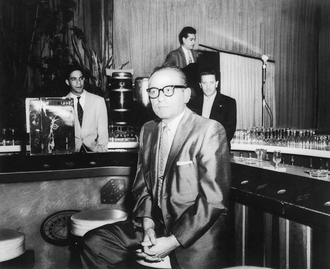 Santo Trafficante Jr. sitting on a stool in front of his bar at the Sans Souci Night Club in Havana, Cuba. - Photo via Library of Congress