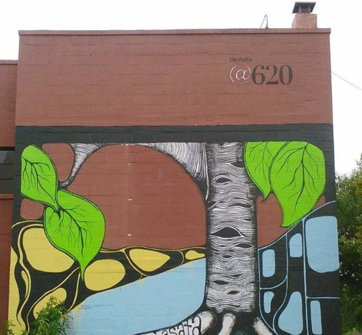 WALL-EYED: Dan Lasata painted the colorful, dreamlike mural on the exterior east wall of the Studio@620.