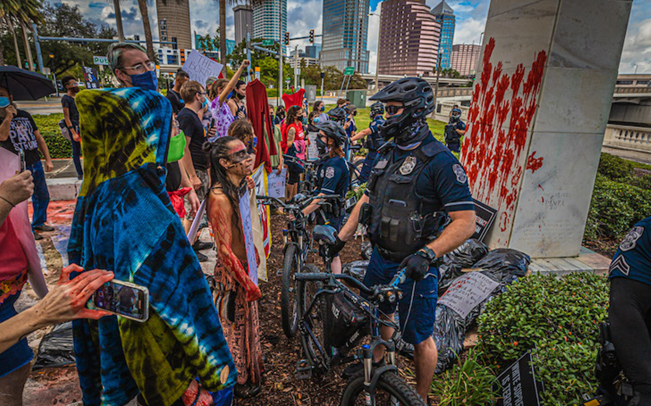 TPD bicycle police defend Tampa's Columbus statue from protesters who put fake blood on it in 2020.