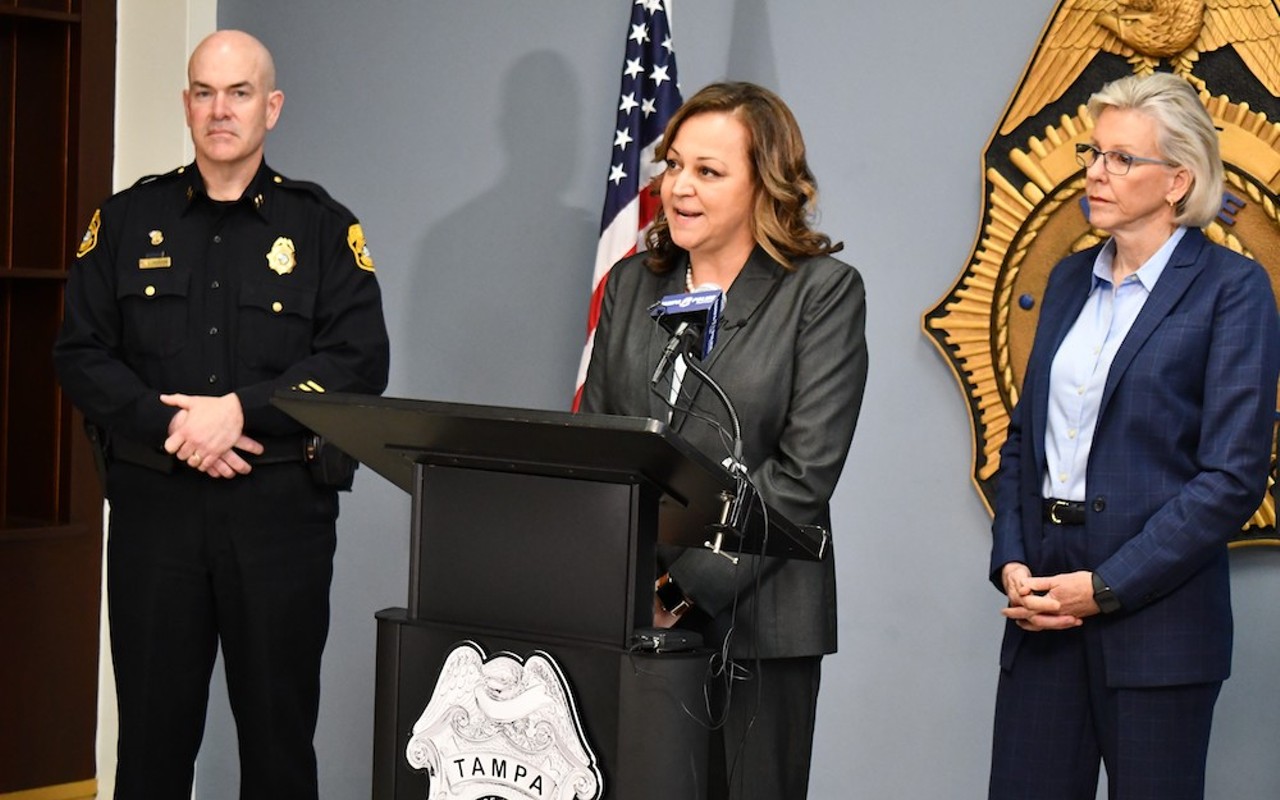 Mary O'Connor speaks during a press conference announcing her new role as police chief next to Assistant Chief Lee Bercaw and Mayor Castor.
