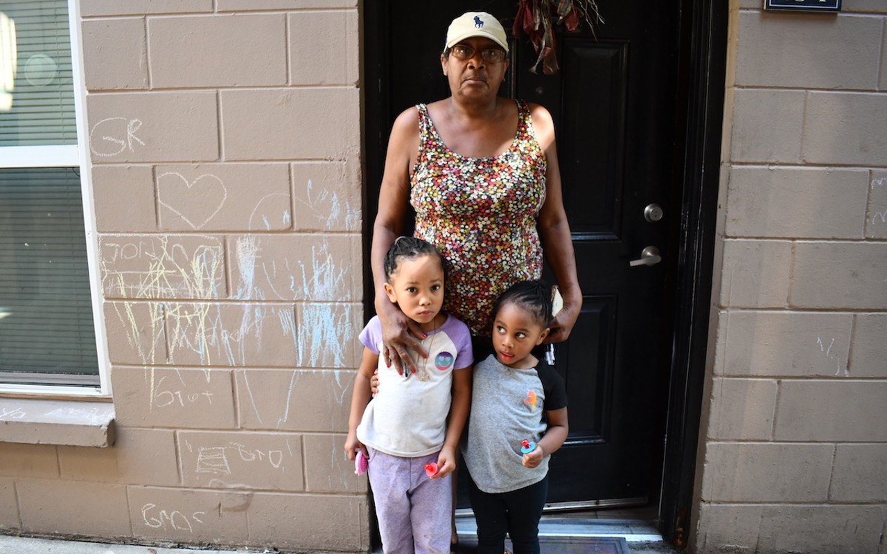 Venita Walden stands outside of her apartment at Silver Oaks with her granddaughters.
