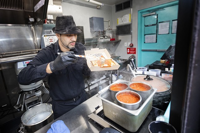 The Corners manager James Maldonado prepares a classic red Detroit-style pizza.