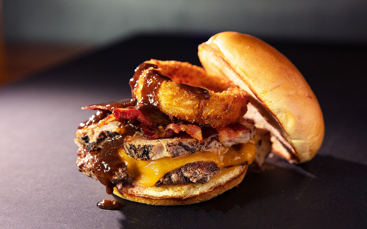 The Ultimate Chophouse Burger with pulled pork, smoked bacon, Cheddar, an onion ring and A.1.