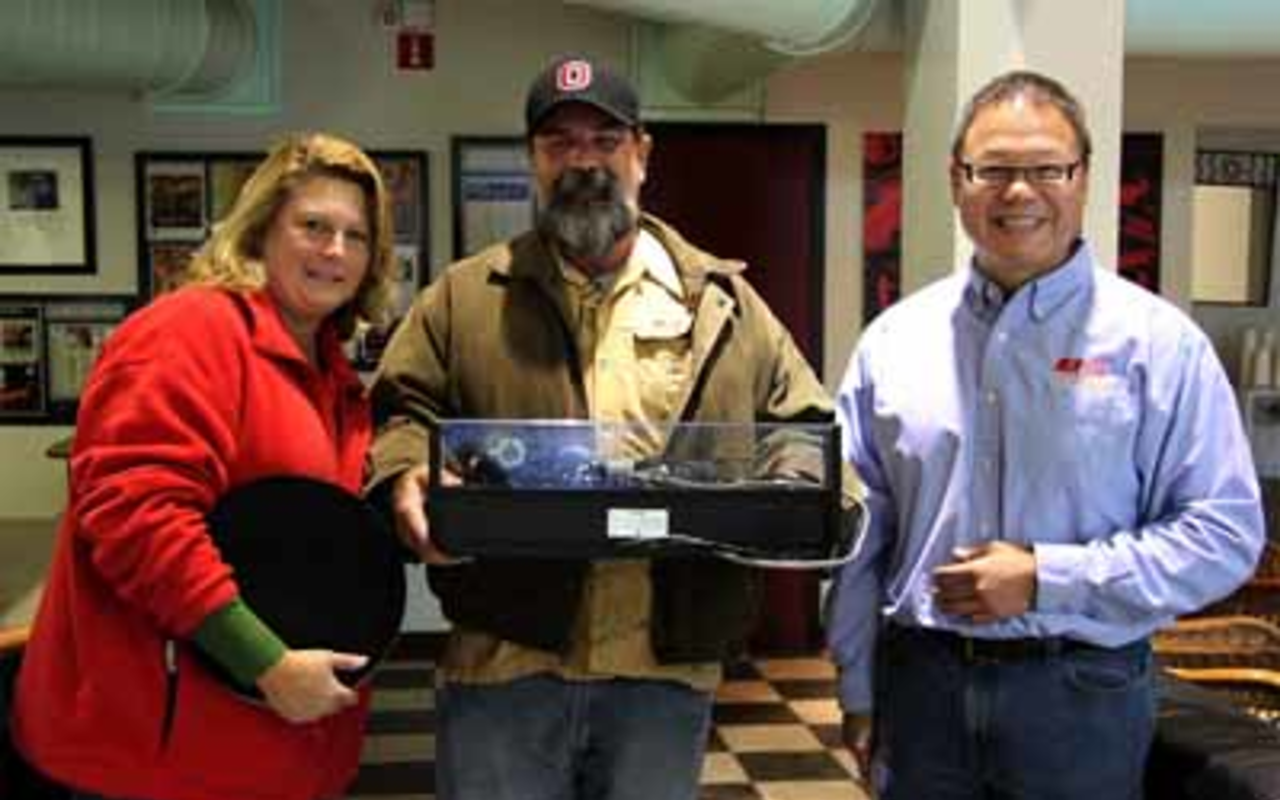 TURN, TURN, TURN: The winner, his wife and George Liu of Audio Visons South with the prize turntable.