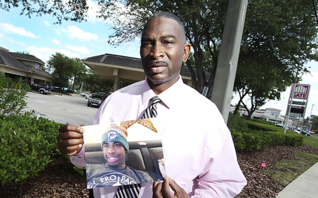 Ron Davis holds the last-known picture of his 17-year-old son Jordan Davis, who was shot and killed at this Jacksonville gas station Nov. 23, 2012.