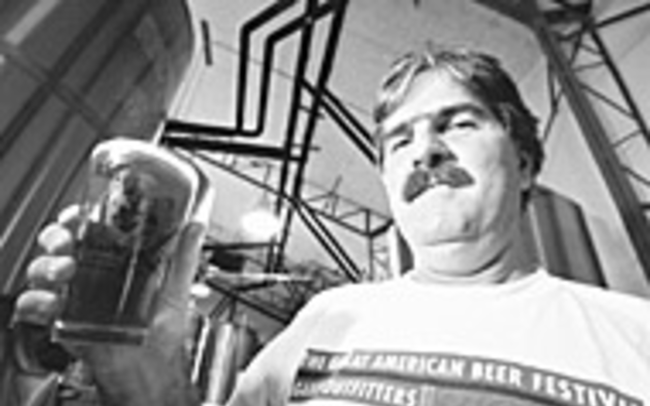 BREWING UP A GOOD TIME: Dunedin Brewery owner Michael 
    Bryant hoists a glass of his homemade beer.